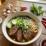 Beef noodle soup with garlic chili oil and bok choy